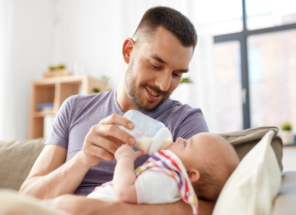 Father feeding a baby from a bottle