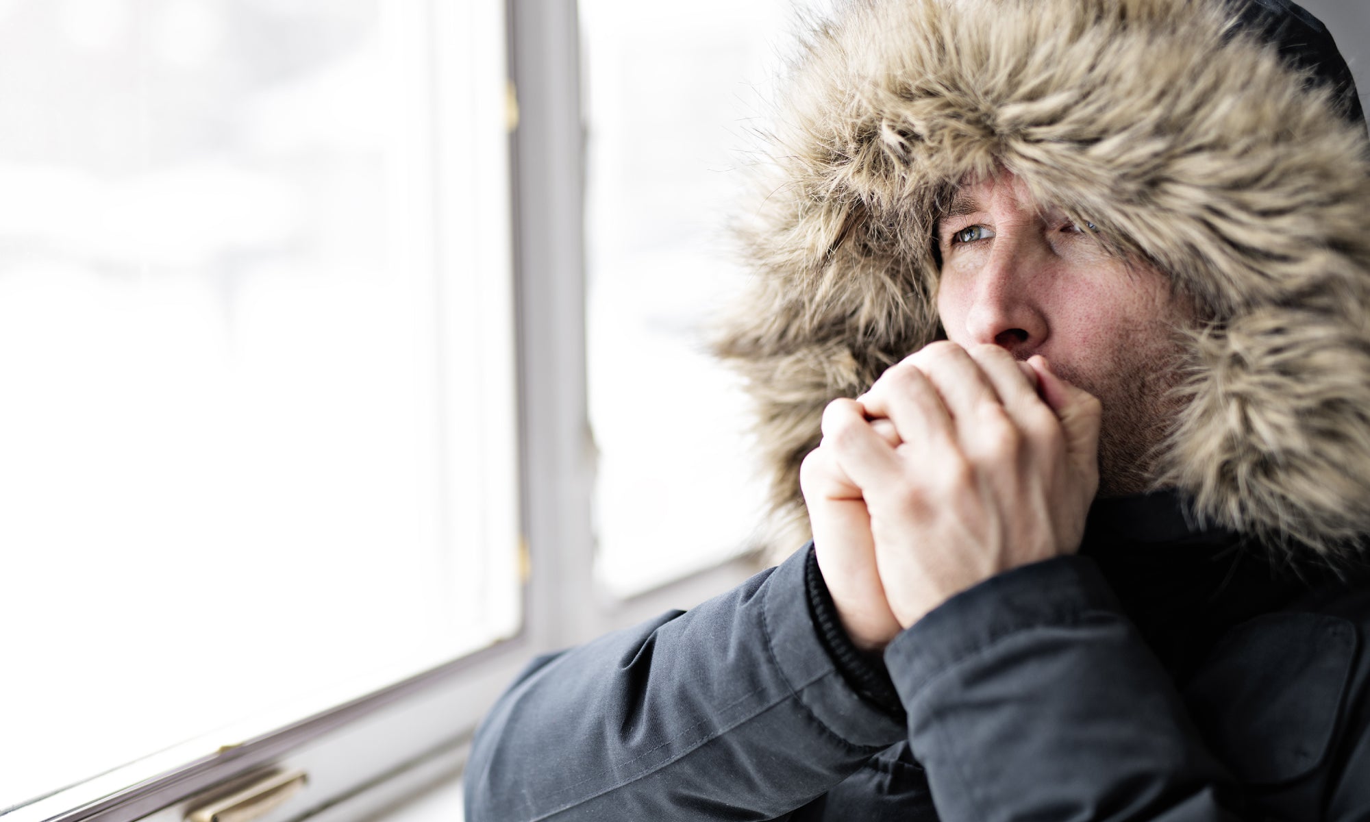 blowing warm air onto hands in cold weather