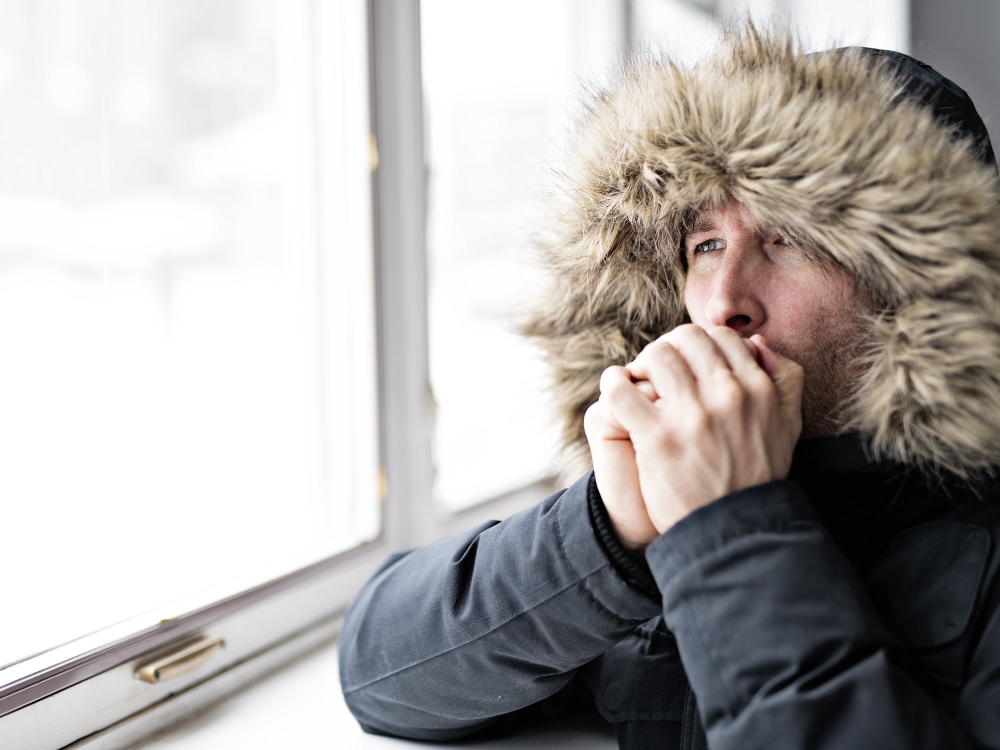 blowing warm air onto hands in cold weather