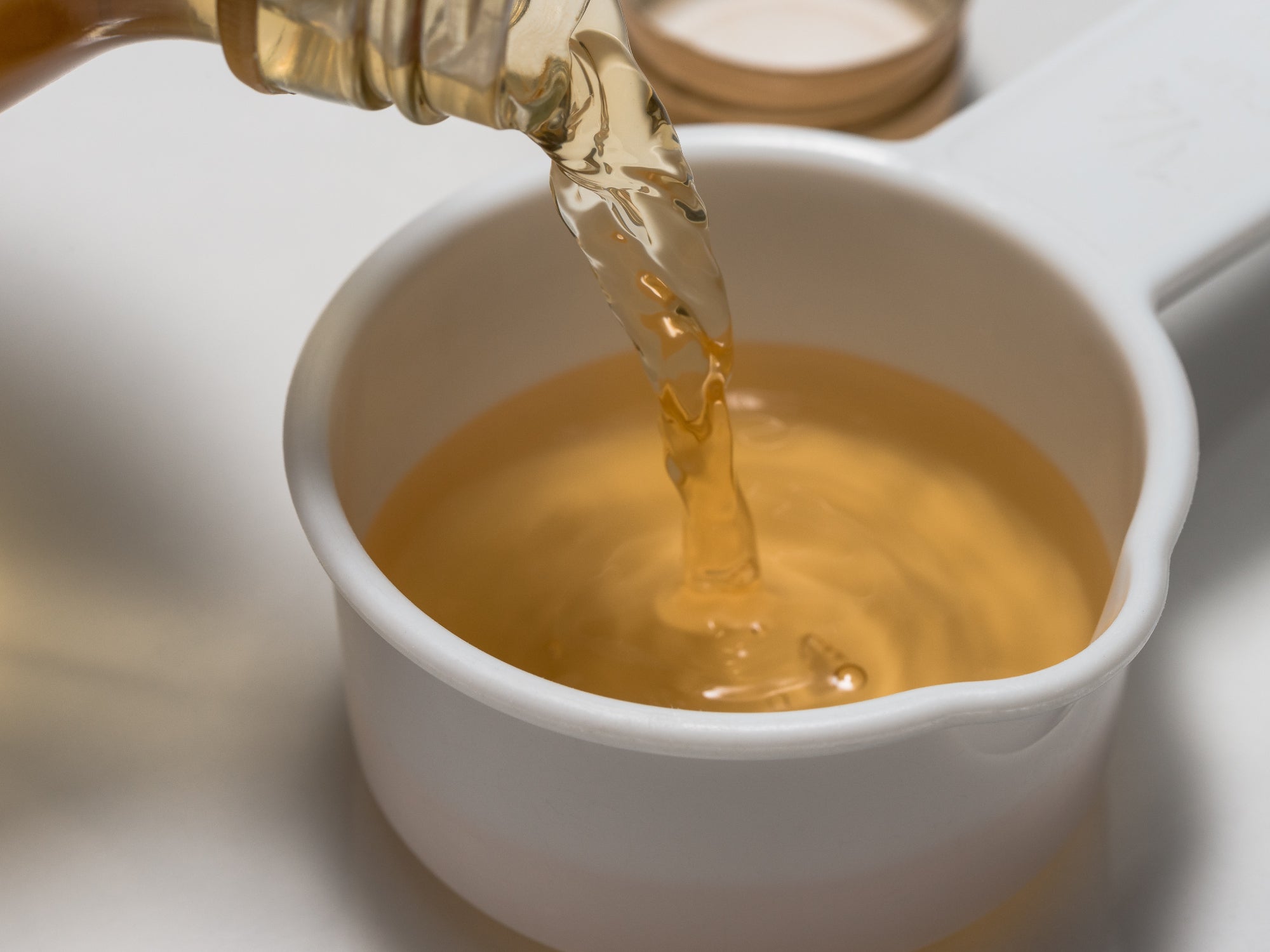 Apple Cider Vinegar pouring into a small bowl