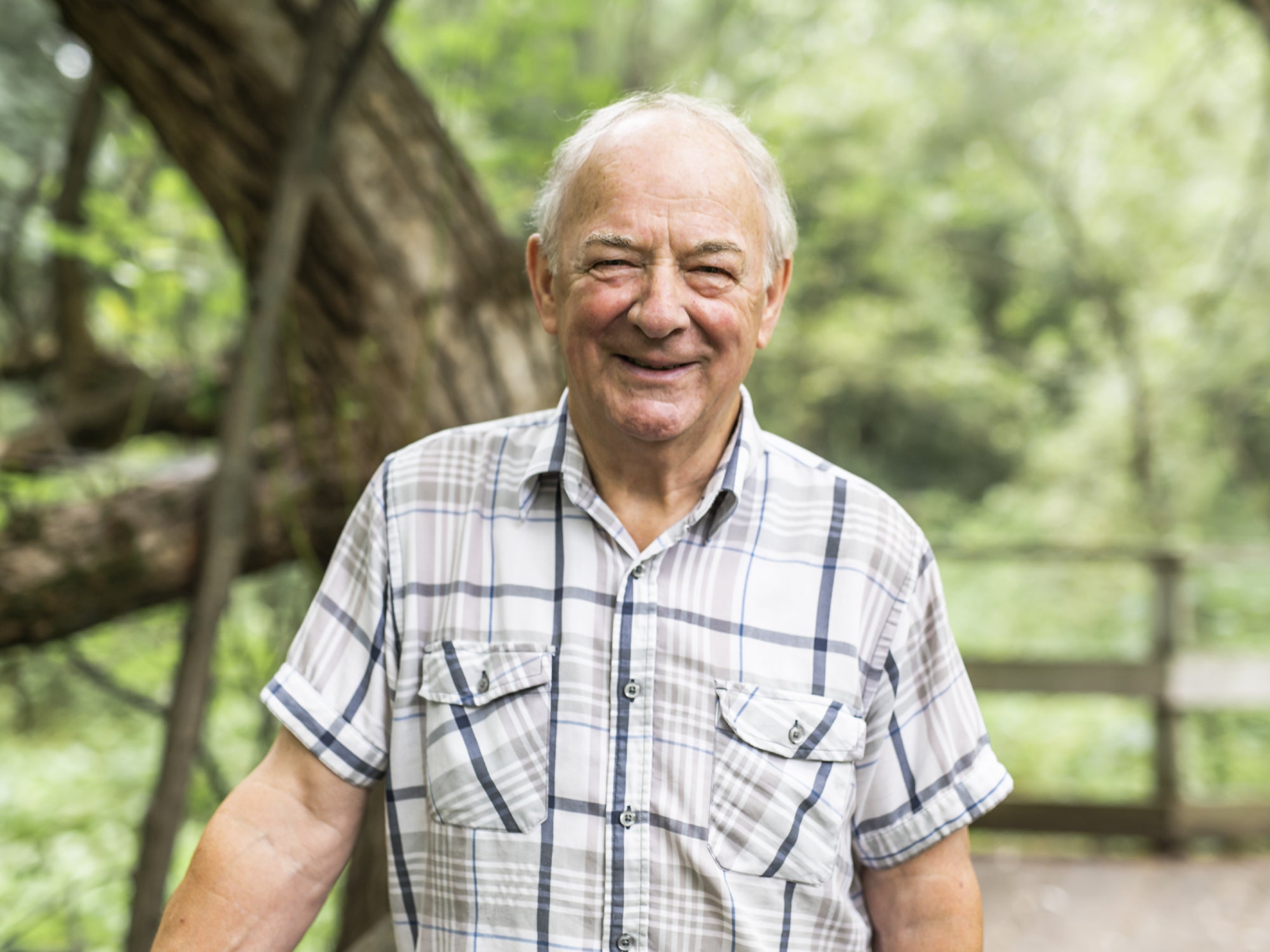 Man in checked shirt walking in countryside