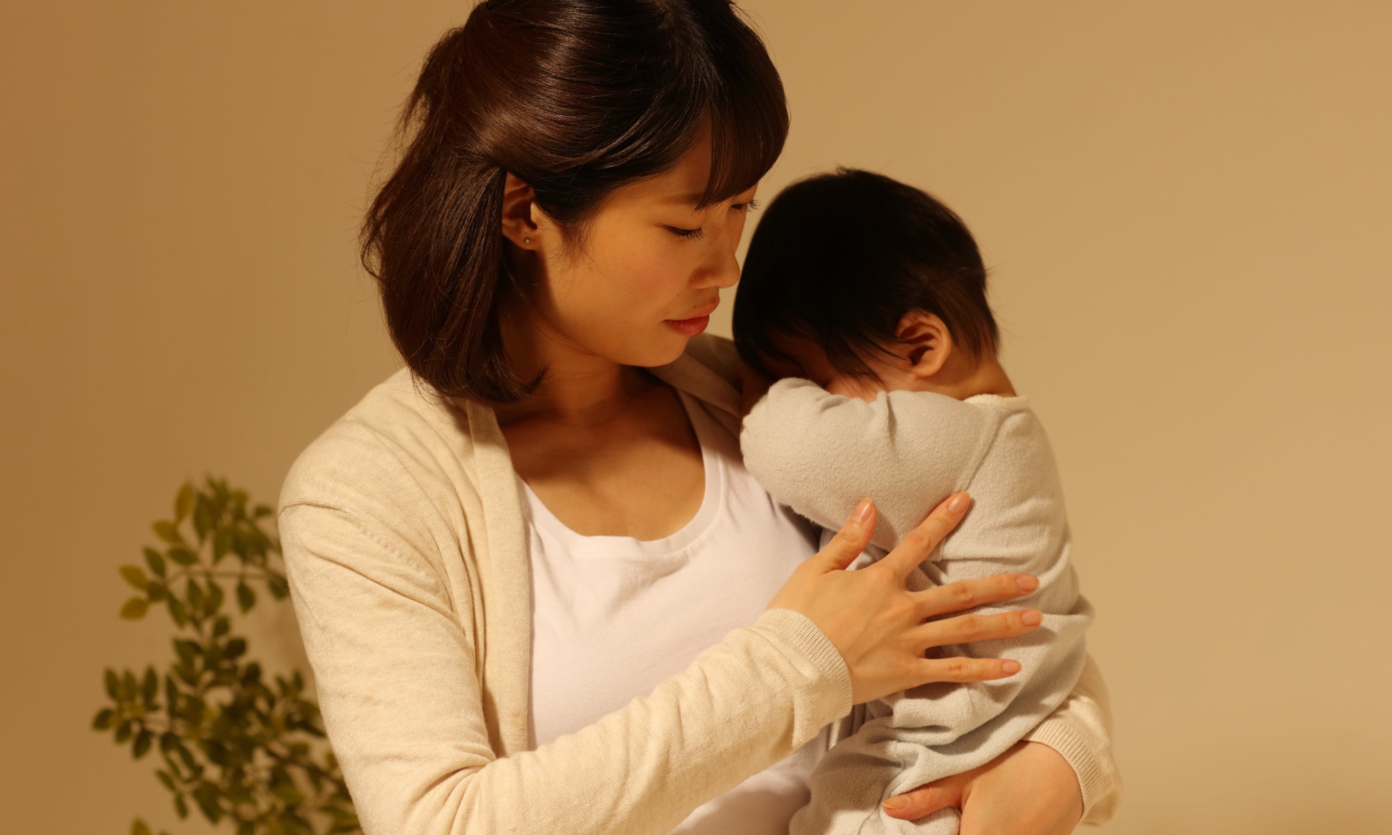 A mother holding a tired baby